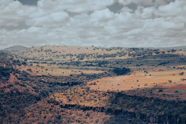 Rolling hills beneath a partly cloudy sky